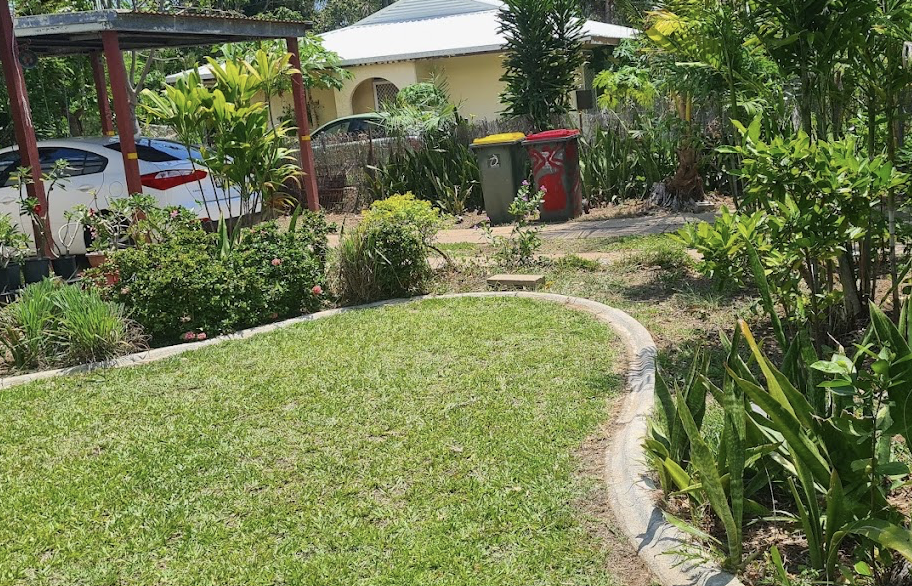 Cleared and edged garden bed alongside a mown lawn at a Hampton Park home